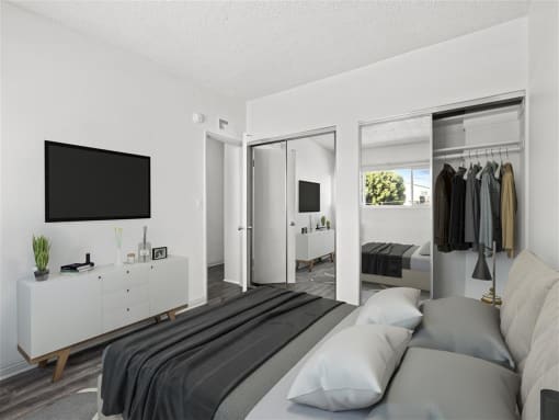 a bedroom with a bed and a tv in a room at Pacific Rose, Los Angeles California