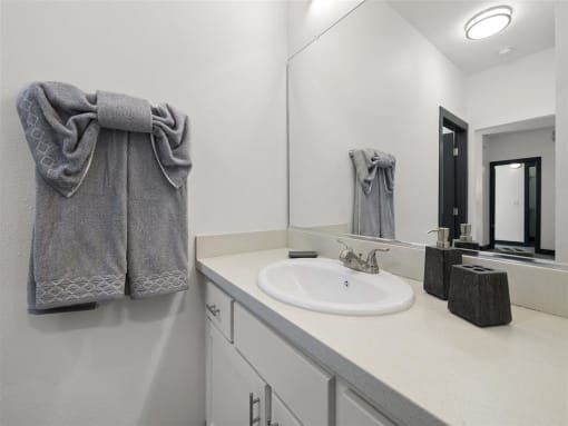 a bathroom with a sink and a mirror at Enclave, Paramount