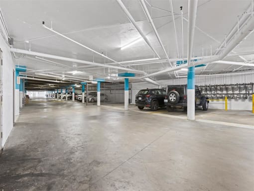 a parking garage with cars parked in it at Enclave, Paramount California at Enclave, Paramount 