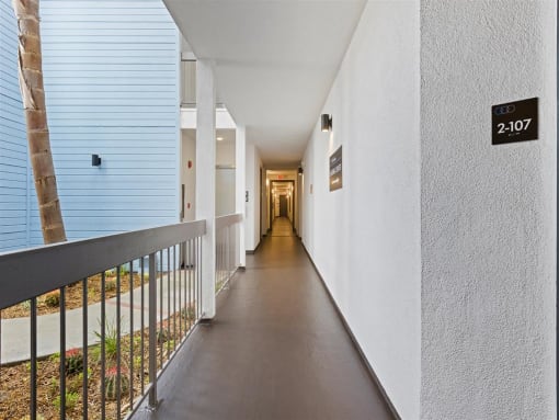 a hallway with a railing and a tree in the distance at Enclave, California