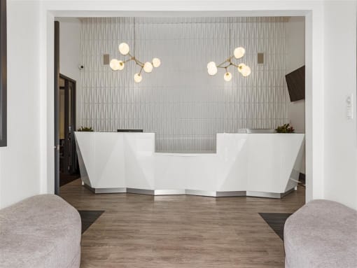 a white reception desk sitting on top of a hard wood floor at Enclave, Paramount, CA 