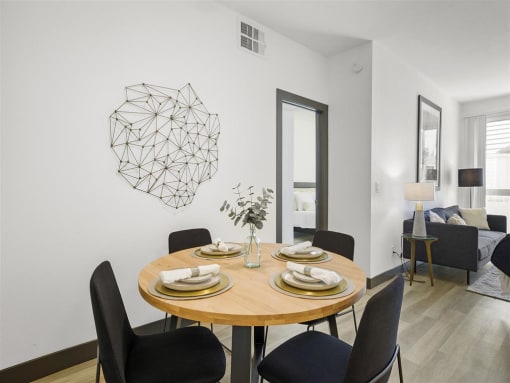a dining room with a table and chairs at Enclave, Paramount California