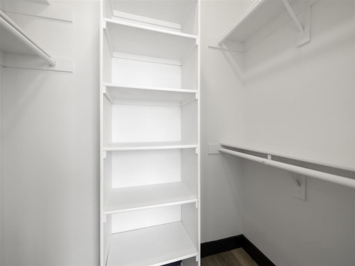 a walk in closet with a white shelving unit at Enclave, Paramount, 90723