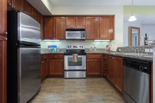 model kitchen with dark brown stained cabinetry and stainless steel appliances