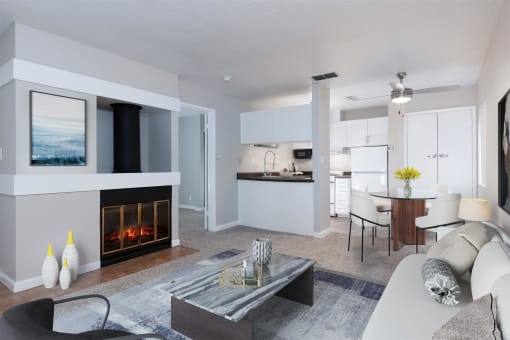 a living room with a fireplace and a dining room and kitchen