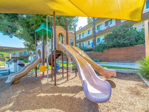 a playground with slides and a swing set