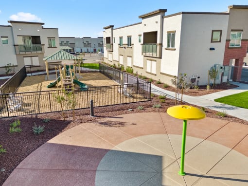 an empty playground in the middle of an apartment complex