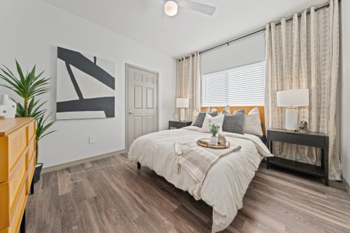 a bedroom with a large bed and a window