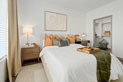 a bedroom with a bed and a tray of food on it