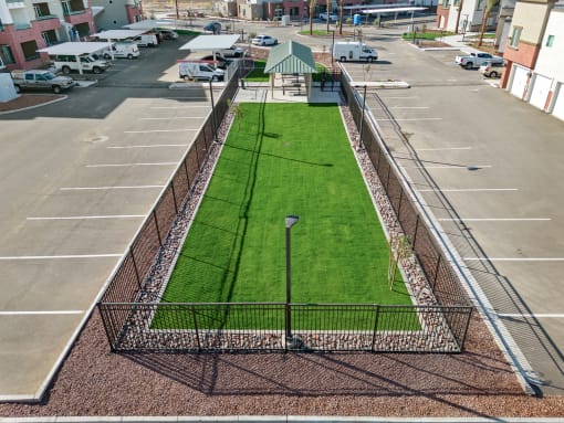 a grass field in the middle of a parking lot