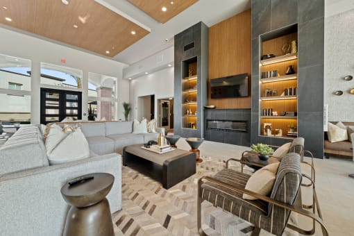 a living room with couches and chairs and a fireplace