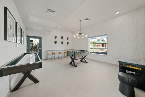 a game room with two shuffleboards and a foosball table