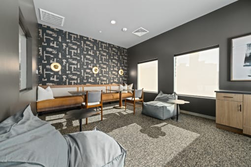 a lounge area with couches and chairs and a wall with a mural of skulls