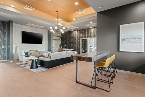 a living room with a table and chairs and a tv