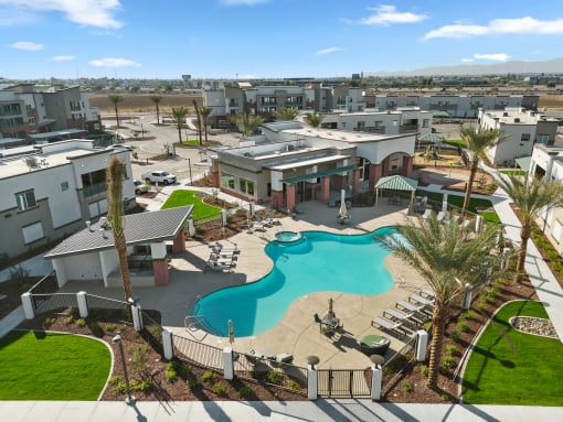 An aerial view of the resort style pool with cabanas and sun deck at Cardinal 95 new apartments in Glendale, AZ.