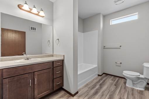 A bathroom with a white toilet and a white sink.