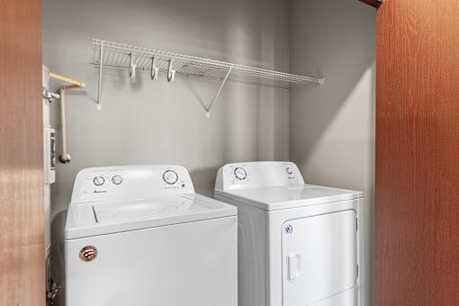 A white washing machine and dryer in a small laundry room.