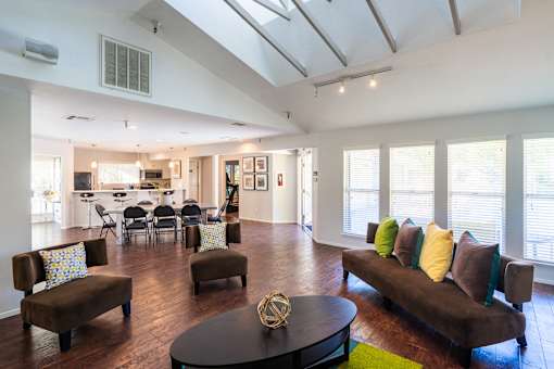 A living room with a brown couch and a coffee table.