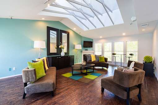 A living room with a grey couch and a brown chair.