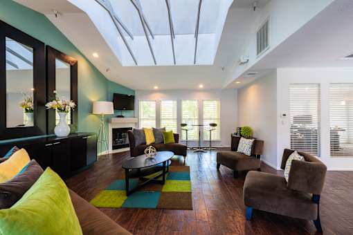 A living room with a glass ceiling and a fireplace.