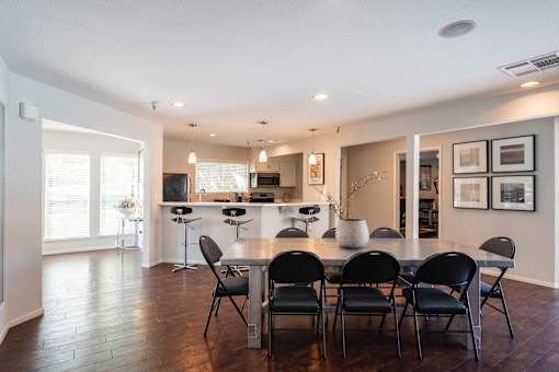 A dining room with a table set for six.