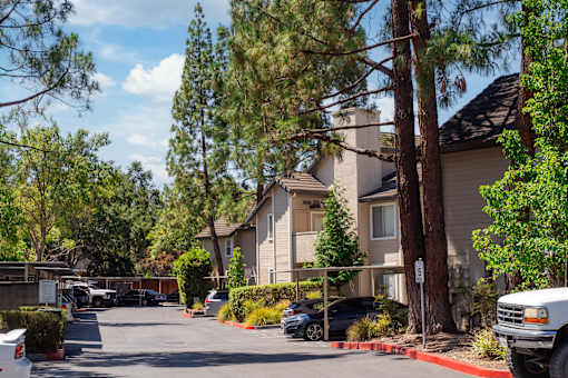 A white truck is parked on the right side of a street.