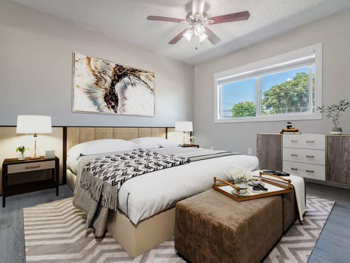 a bedroom with a bed and a ceiling fan