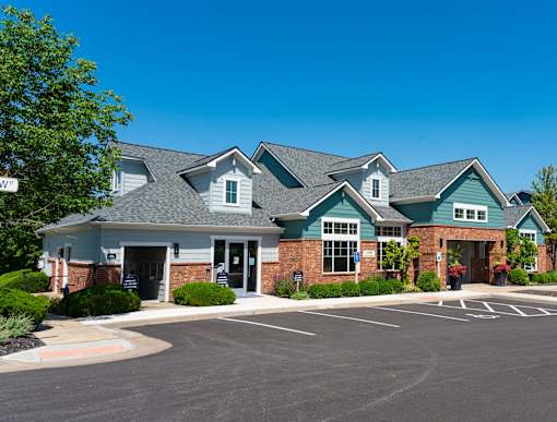 a large house with a parking lot in front of it