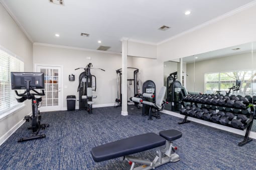 a gym with cardio equipment and exercise machines