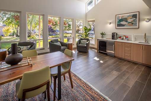 a dining room and living room with a table and chairs