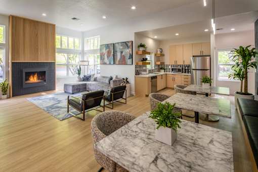 A modern living room with a fireplace and a dining table.