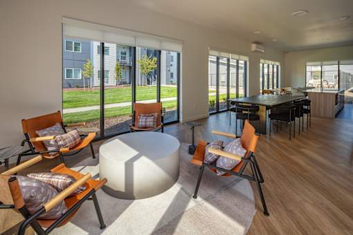 A modern living room with a large table and chairs at The Arvon, 98662