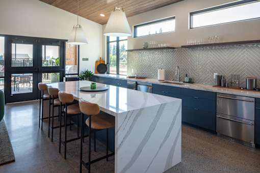A kitchen with a bar area and a dining table.