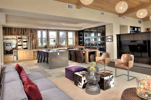 A modern living room with a grey sofa and a wooden ceiling.