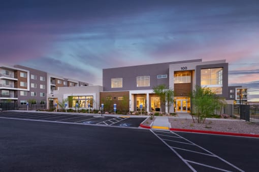 a parking lot in front of an apartment building at sunset at Element 12 Apartments, Henderson NV