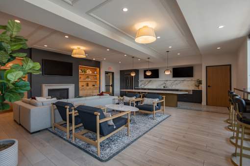 A modern living room with a fireplace and a TV on the wall.