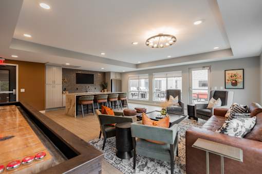 A living room with a pool table and a couch.