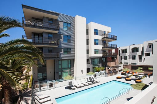 a view of the pool and exterior of building
