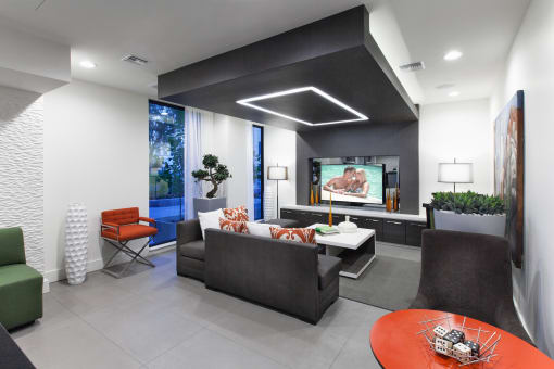a living room with black and white walls and a tv on the wall