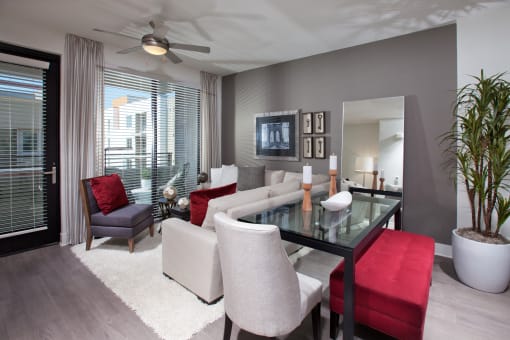 a living room filled with furniture and a large window