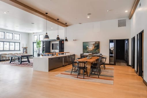 a large living room with a dining room table and a kitchen