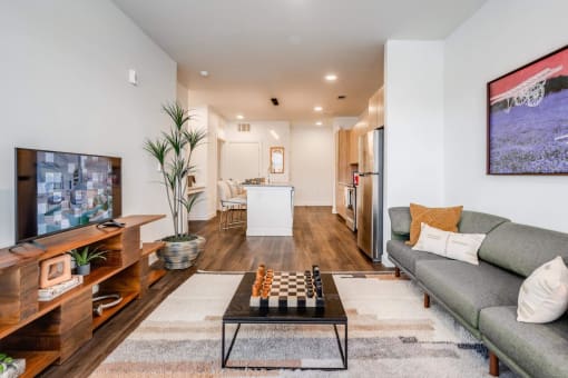 a living room with a couch and a table with a chess board