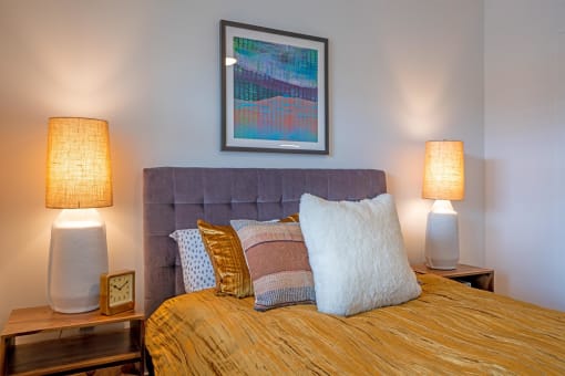 a bedroom with a bed and two lamps