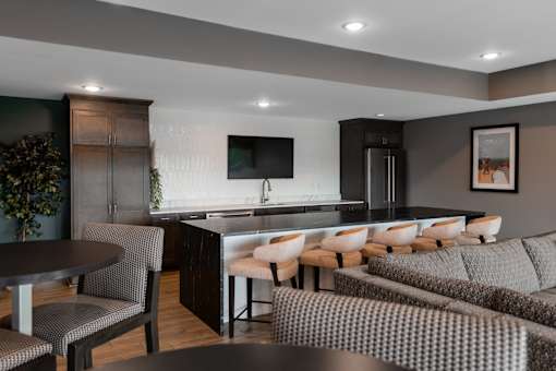 A modern kitchen with a dining table and chairs.