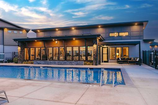 A modern house with a pool in the backyard.