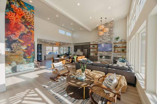 A living room with a large painting on the wall and a fireplace.