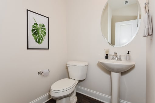 a small bathroom with a toilet sink and mirror