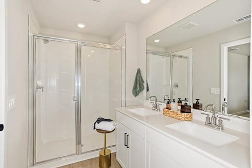 A bathroom with a white sink and a gold stool.