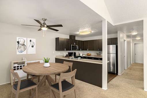 A modern kitchen with a dining table and chairs.