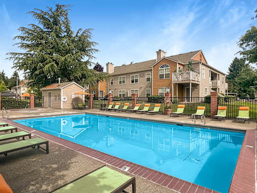 A large swimming pool surrounded by lounge chairs